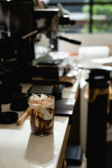 Iced coffee with ice cubes in cafe. Selective focus.