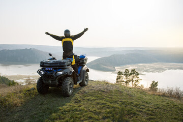 Happy man on a quad bike atv off road. atv ride extreme journey