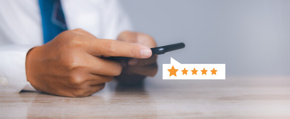 Businessman touching giving high score for feedback review satisfaction service. Customer satisfaction experience with five star icon and excellent for feedback review satisfaction service.