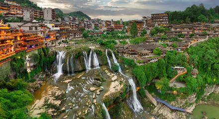 Beautiful ancient town in China with waterfall and traditional houses