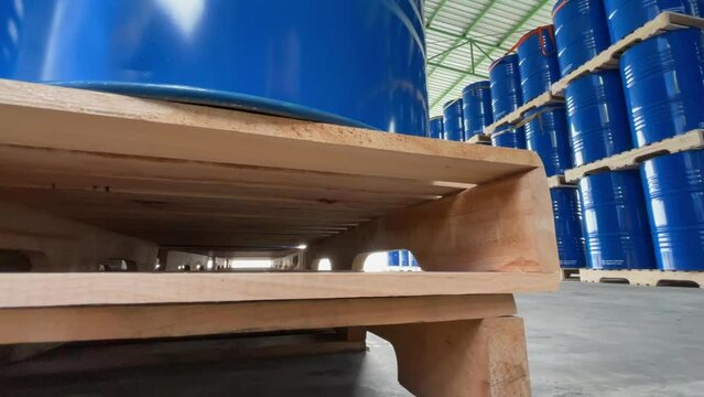 Industrial and environmental work concept with a blue 200-liter storage tank for chemicals and oil products in a chemical storage area of a firm.