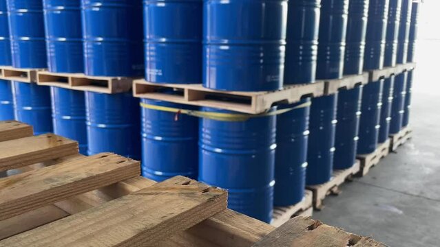 Blue 200 liter chemical and oil product storage tank placed in a Chemical storage area inside an industrial factory, industrial and environmental work concept.