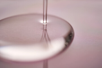 A juicy drop of gel on a purple background.