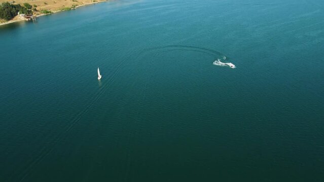 Sailboat And Ski Jet In The Sea