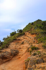 Hiking Trail, grassy plains and hills, in Horton Plains National Park, Central highlands of Sri Lanka.