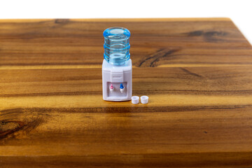 Doll sized water dispenser and two tiny drinking mugs