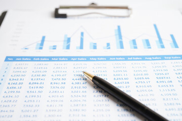 Pen on chart or graph paper. Financial, account, statistics and business data concept.