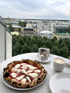 Pizza On The Table Overlooking The City