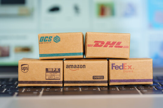 Shipping Boxes on laptop. Popular worldwide shipping and logistic company, Amazon, DHL, FedEx, UPS and OCS express delivery from online shopping. Bangkok, Thailand, 11 June 2023