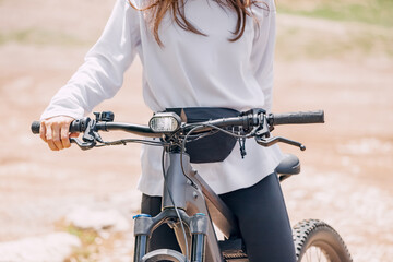 Pretty girl on a modern electro mountain bicycle. Bike sport and outdoors recreation