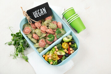 Vegetarian food. Colored dumplings in a plate/on board.