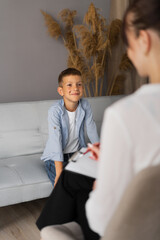 Preschooler boy visiting psychotherapist, woman and child talking about problem, psychotherapy...