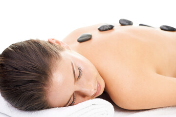 Obraz na płótnie Canvas Woman, massage and spa treatment with hot stone, relax and dermatology at wellness center. Female person, physical therapy and resting on bed with cosmetics isolated on transparent, png background