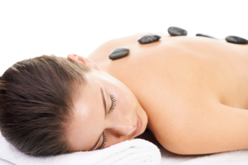 Woman, massage and spa treatment with hot stone, relax and dermatology at wellness center. Female person, physical therapy and resting on bed with cosmetics isolated on transparent, png background