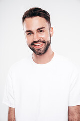 Obraz premium Portrait of handsome smiling stylish hipster lambersexual model. Sexy man dressed in white T-shirt and jeans. Fashion male isolated on white background in studio. Closeup