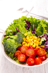 Obraz na płótnie Canvas mixed vegetable salad with tomato, broccoli, tomato,corn and lettuce