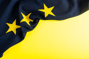 Overhead view of flag of europe over yellow background, copy space