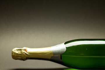 Close-up of champagne bottle isolated against gray background, copy space