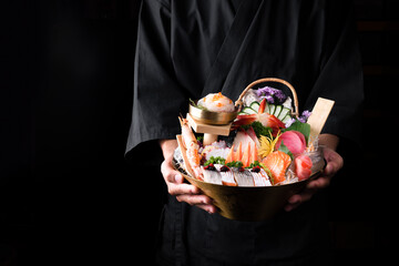 Japanese food, salmon sashimi in an Asian restaurant, Chef hands preparing japanese food, japanese...