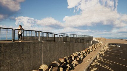 海岸の駐車場のスロープで海を見つめる若い女性