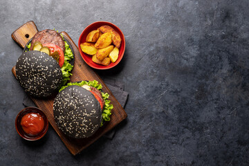 Homemade beef burgers with black buns
