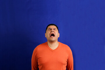 40-year-old latino man screams desperate, frustrated, anguished and distressed