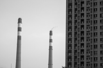 Black and white photos of chimneys and apartments, concept of urban pollution