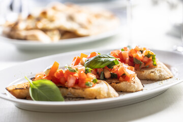Bruschetta with tomatos and basil served on a crunchy bread