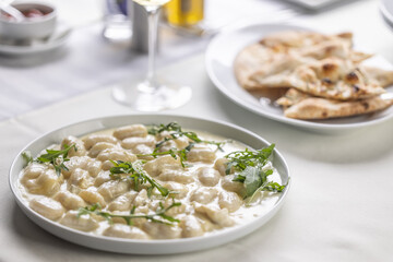 Gnocchi with cheese, hearty food from northern Italy, served with ruccola