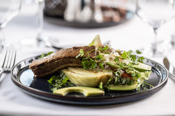 Salad with artichoke and avocade with marinated tofu on top of it