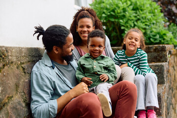 Happy black kid and his family enjoys in their time together outdoors.