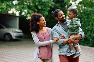 Happy black family enjoys while spending time together outdoors.