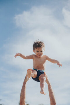 Happy, smiling multiracial Asian toddler on Oahu beach.