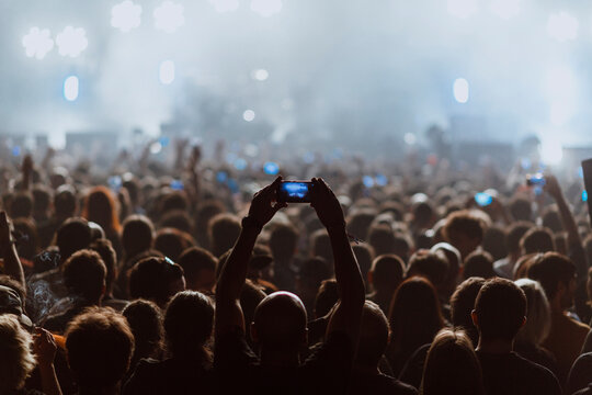 People recording a rock concert with their cell phones