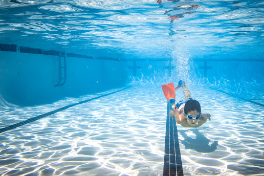 Underwater photograph of boy swimming.