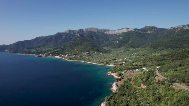 Aerial View Over Kinira View Point With High Mountain Peaks, Lush Green Vegetation, Mountain Road And Tropical Beaches In The Distance, Thassos Island, Greece