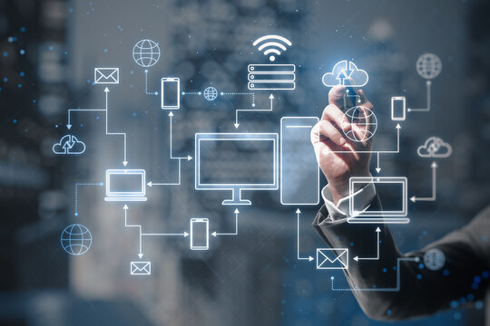 Cloud computing technologies concept with man hand using stilus on virtual touch screen with digital electronic devices connected between each other on blurred abstract background