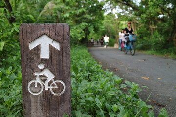 Cyclists and cyclist's lane signs in the garden