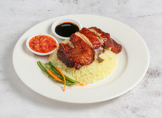 roasted chicken rice with chilli and soy sauce served in dish isolated on banana leaf top view of singapore food