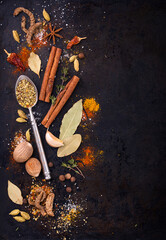 Different spices and herbs on a black background