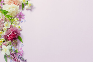 Fototapeta na wymiar beautiful summer flowers on light purple background