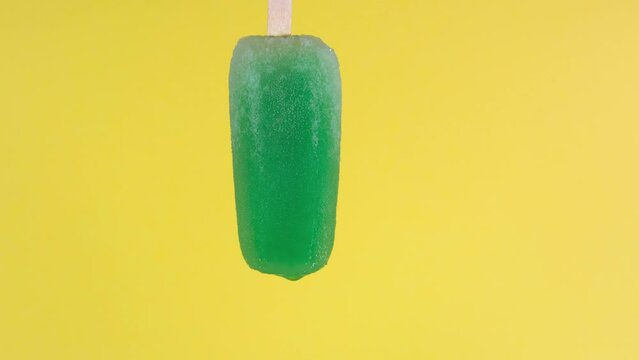 Mint flavored popsicle that melts quickly in time lapse