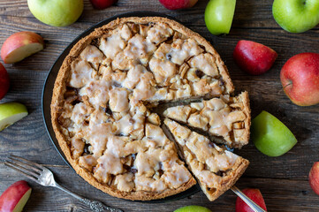 Whole and round apple pie baked with short crust pastry, precooked apples, cinnamon and raisins....