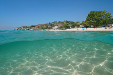 Beach shore in summer on the Atlantic coastline in Spain, Galicia, split level view over and under water surface, Rias Baixas