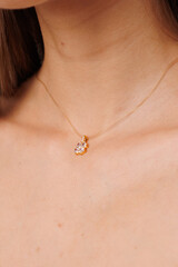 Beautiful young girl with fresh  healthy skin. Woman advertise ear-rings. White background. Earrings closeup. Blond european woman with long hair with big lips, pretty smile. Cosmetology,  scincare