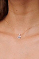 Beautiful young girl with fresh  healthy skin. Woman advertise ear-rings. White background. Earrings closeup. Blond european woman with long hair with big lips, pretty smile. Cosmetology,  scincare