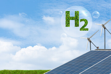 H2 with green leaves , wind turbines and solar panels on blue sky background.