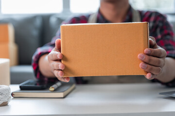 Entrepreneurs Small Business SME Independent men work at home Use smartphones and laptops for commercial checking, online marketing, packing boxes, SME sellers, concept, e-commerce team, online sales