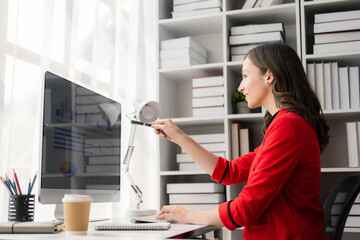 Successful businesswoman using laptop and computer while making paperwork for financial mathematics analytical research concept