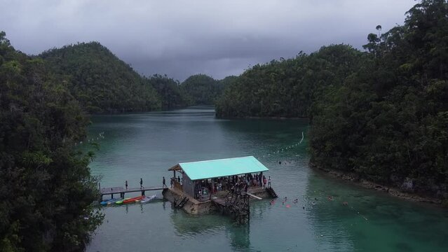 Aerial, Tourists swimming by floating pontoon-style lodge of Sugba Lagoon in Siargao Island, Philippines.
Mystical Water maze Enclosed By Lush limestone conic Hills wrapped in a layer of vegetation